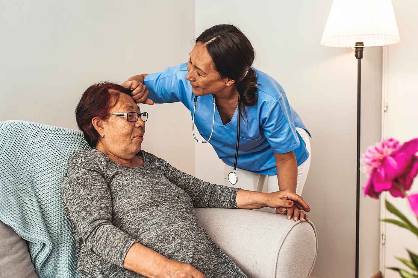nurse performing a health checkup on a senior resident